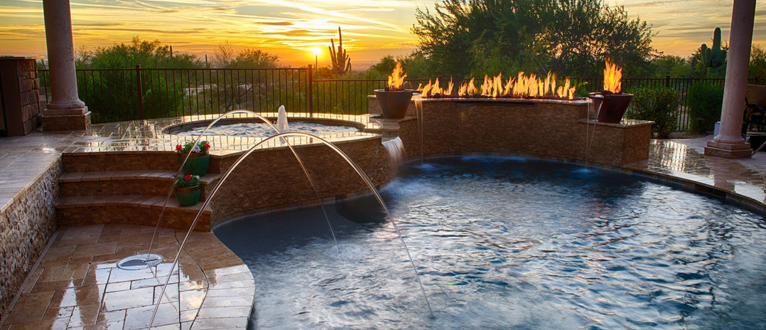 Custom swimming pool, hot tub, fountains and fire pit at sunset. Outdoor Living style.
