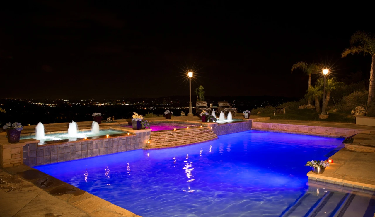 Custom backyard swimming pool at night
