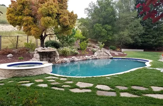 Custom pool and spa combo design with raised spillover spa